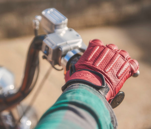 CE approved red leather motorcycle gloves by 78 Motor Co riding a Harley Davidson motorcycle.