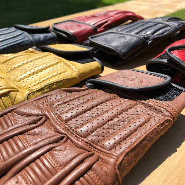 cool vintage motorcycle gloves in bright colours in the sun